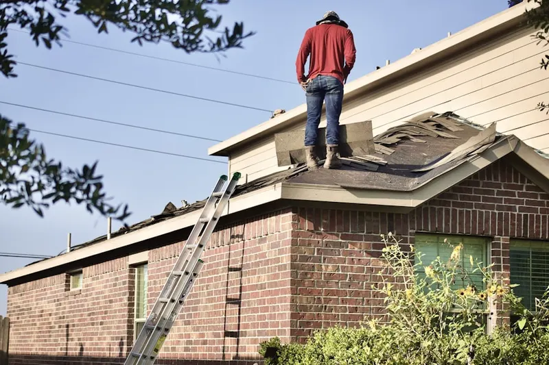 Professional roofer working on a residential roof in Yucca Valley